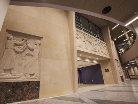 The stone reliefs by German-American sculptor Anton Grauel at the former entrance of the Griffith Fine Arts Building were preserved and incorporated into the interior of the newly renovated building.  Photo by Michael Tubbs '05, '10 & '11
