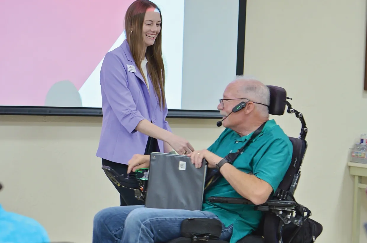 Scott greets Parkinson Voice Project patients for their singing therapy session.
