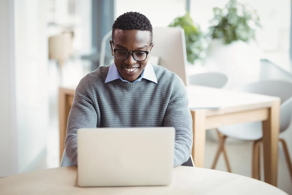 Male sitting at a laptop working