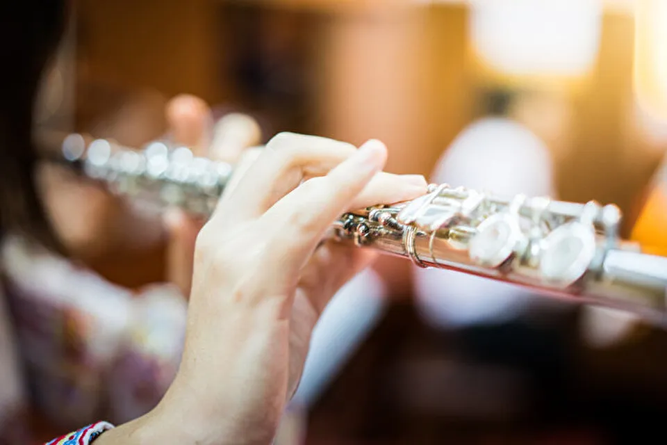 Close up of a person playing a flute