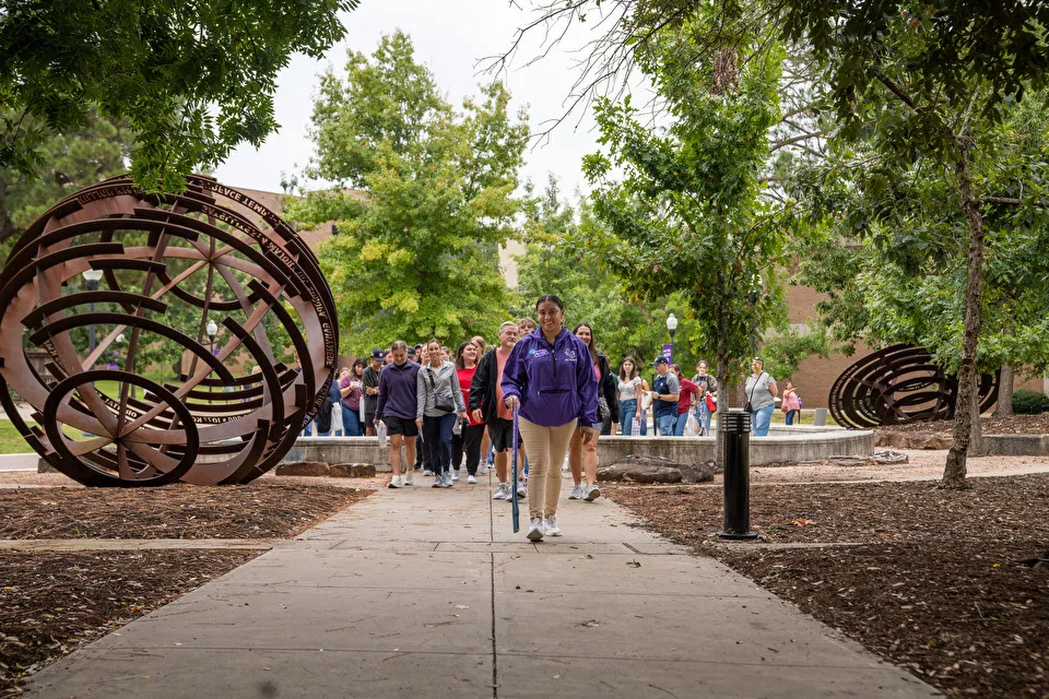 A Jack Walker student tour guide leads prospective students and their families on a tour of campus A Jack Walker student tour guide leads prospective students and their families on a tour of campus