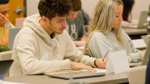 Student takes notes in class