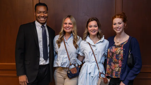 Four students smiling