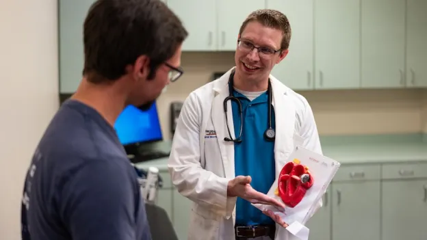 Nurse student and educator talking about heart model