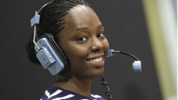 Female camera operator smiling at the camera