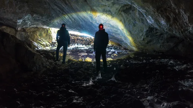 two people exploring a cavern