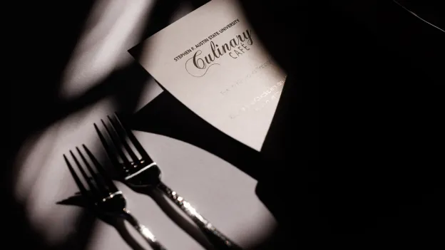 Closeup view of a Culinary Cafe menu and forks