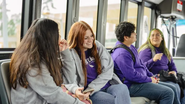 Students socializing while riding the campus bus