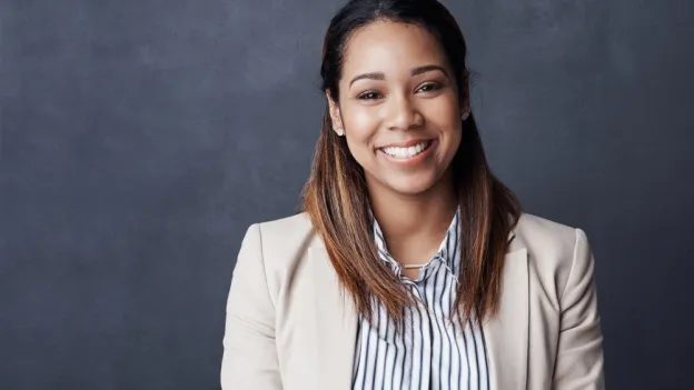Woman professionally dressed smiling at the camera