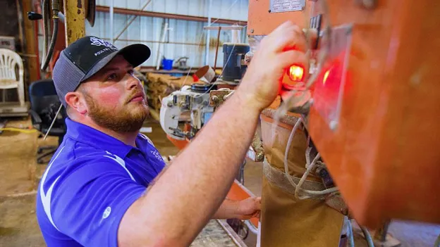 student working on machinery
