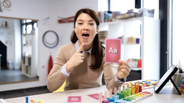 Instructor showing how to pronounce A