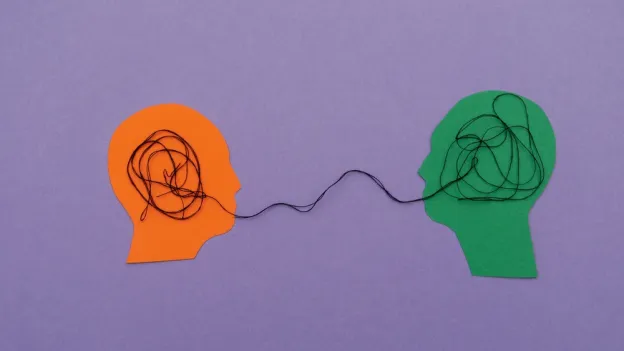 silhouette of two heads with string showing a connection
