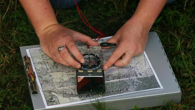 person using tools to mark map