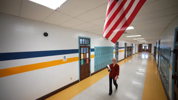 Person walking down a school hallway