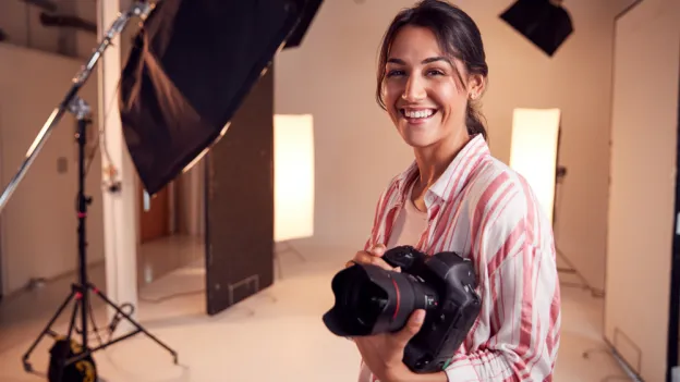Female Photographer Standing In Studio