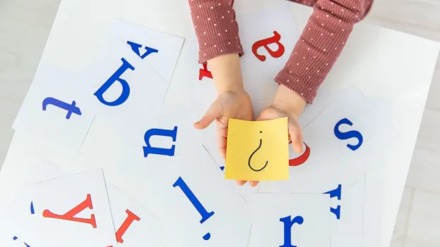 collage of letters with child holding a question mark
