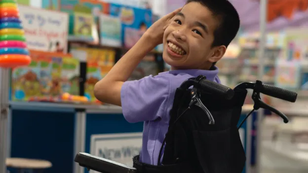 Child using a wheelchair in a classroom