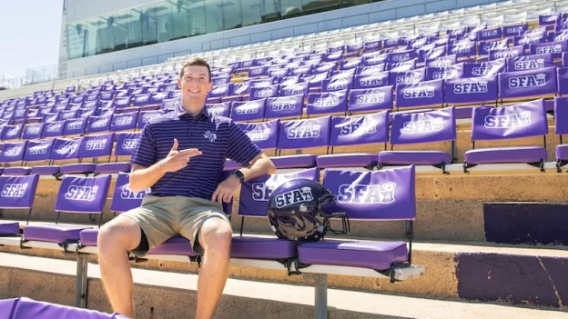 Student sitting in the stands at Homer Bryce Stadium