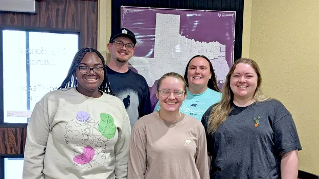 Five SFA alumni participants in the JacksTeach program stand for a photo