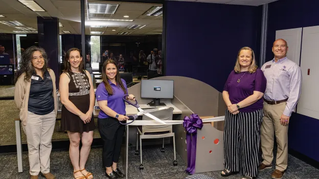 Members from SFA and the Nacogdoches community present a family-friendly workstation during a ribbon-cutting event