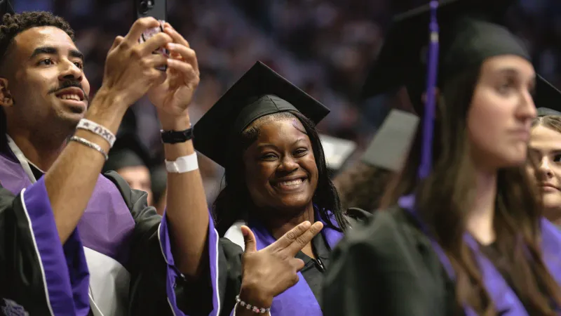 Students in regalia celebrating their graduation commencement