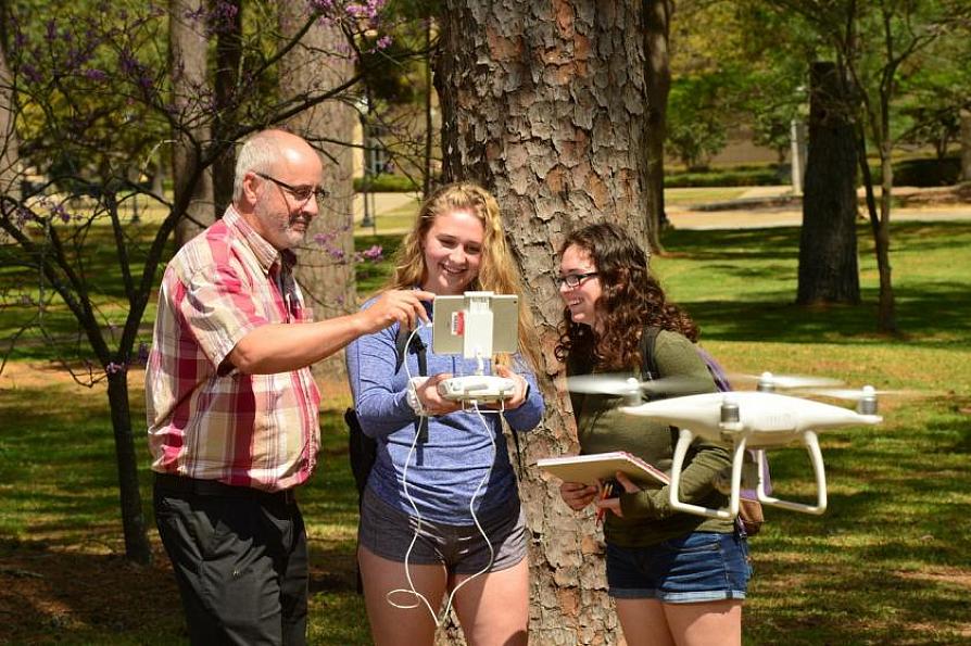 spatial science students working with a faculty member