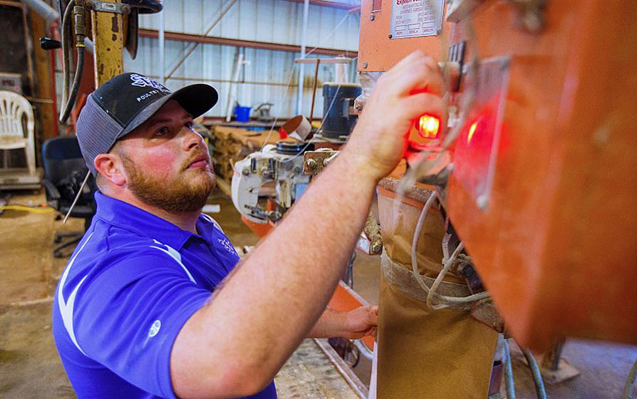 ag engineering student working on farm equipment