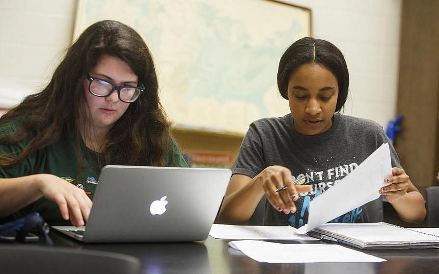 Two agribusiness students working at a desk