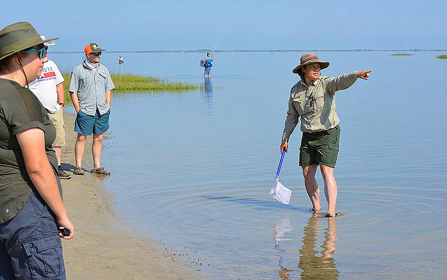 park ranger in lake with bystanders