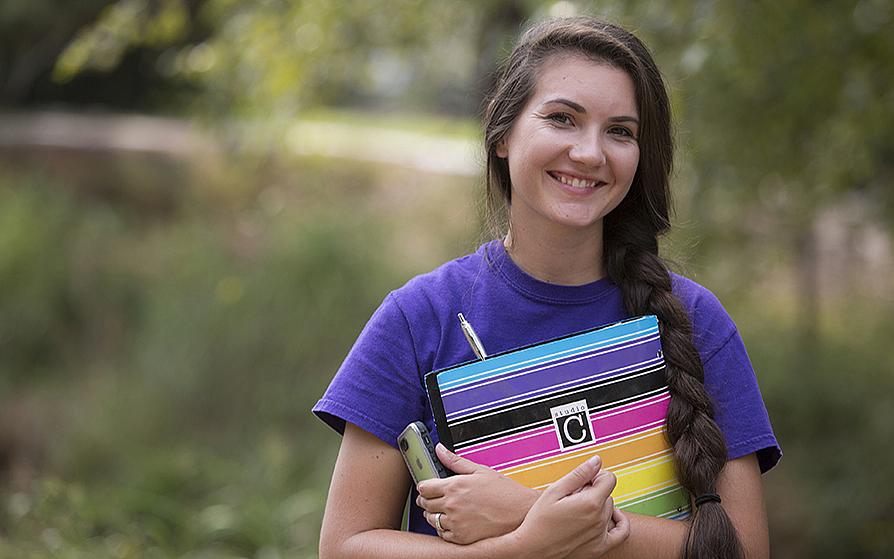 smiling student studying agricultural communications