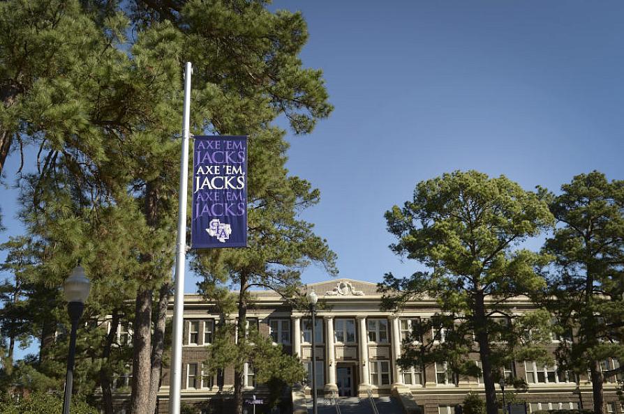Axe 'em banner on display in front of the Austin building