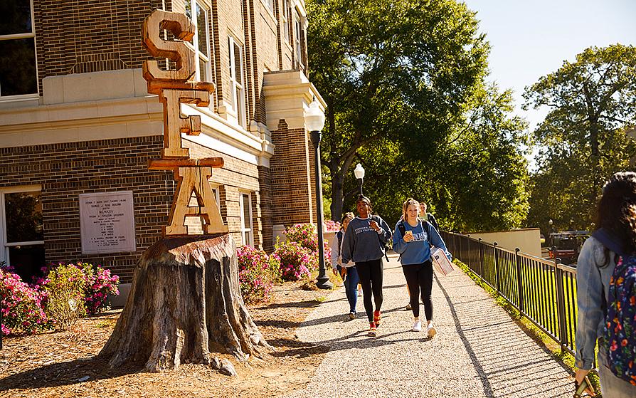 Students walking by the Rusk building