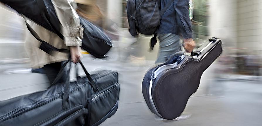 stock image of people carrying guitars