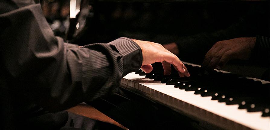 stock image of person playing piano