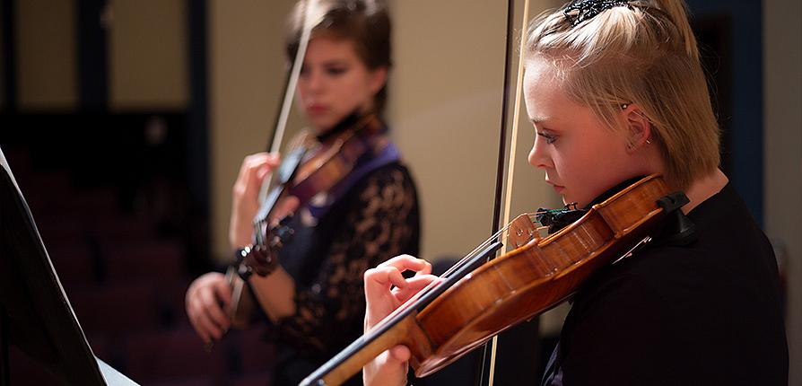 Students playing violins