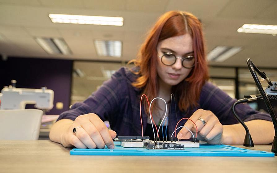 Student working with electronic components