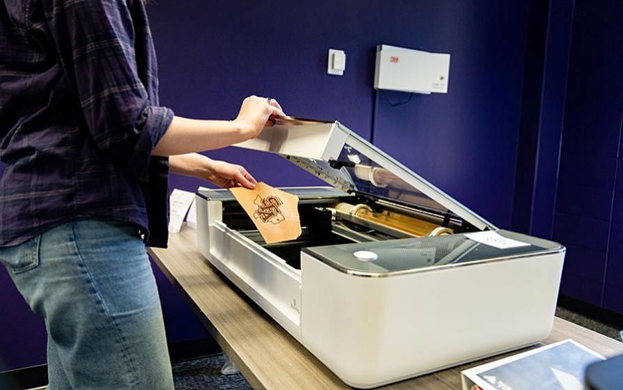 Student using a laser engraver