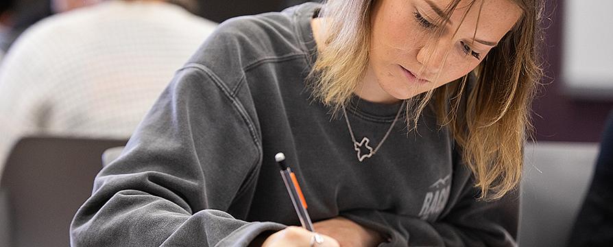 student writing in class