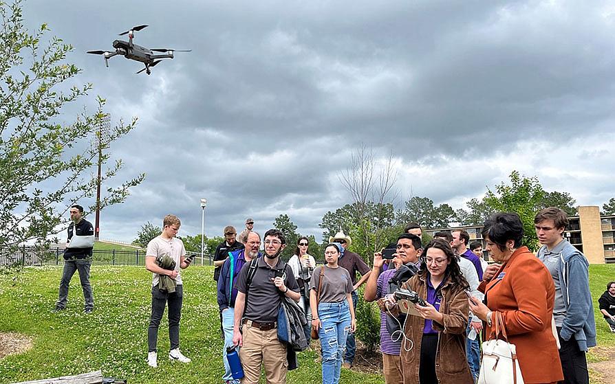 Students flying a drone on campus
