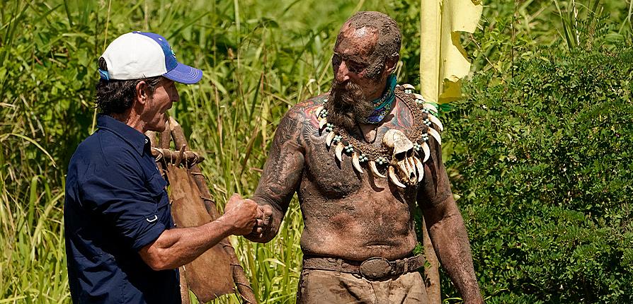 Mike Gabler '93 bumps the fist of "Survivor" host Jeff Probst following a challenge. 