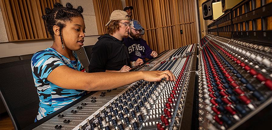 Students recording sound in the studio