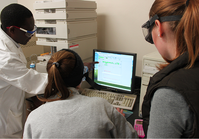environmental science students working with chemistry professor