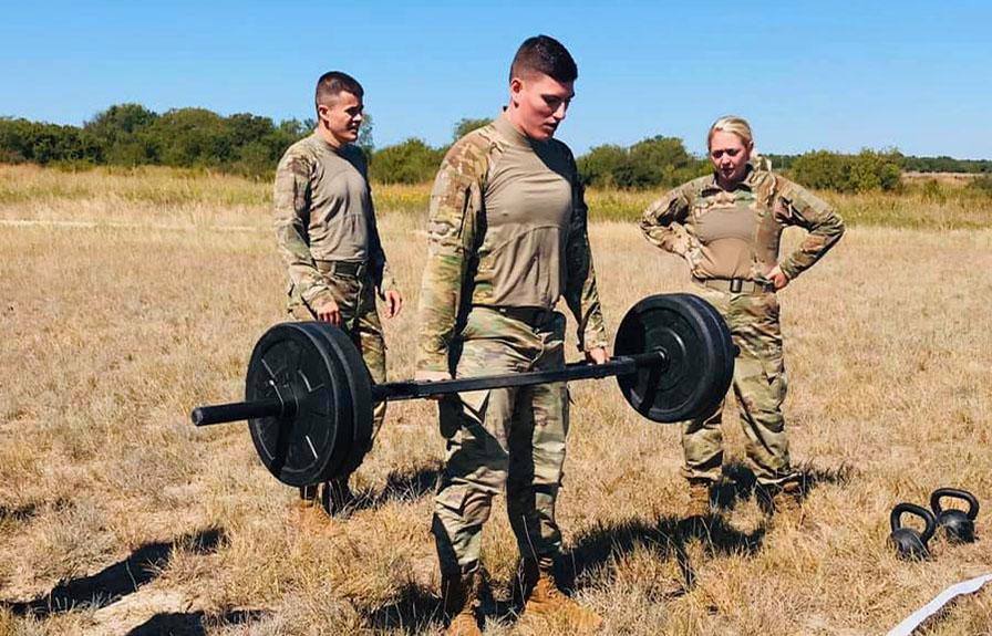Three members of the SFA ROTC Ranger Challenge Team participating in physical competitions