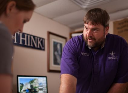 Dr. Matthew McBroom talking to student