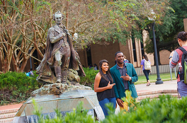 students in front of fountain