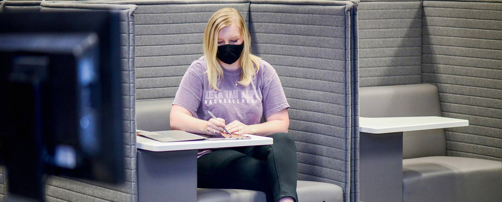 Madison Teale, a senior interior design major, uses a new study unit called an ecopod. The units are located in the Steen Library and equipped with electricity and USB outlets. Photo by Robin Johnson