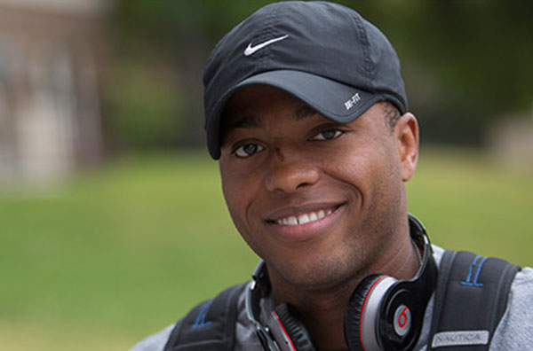 Student in hat smiling