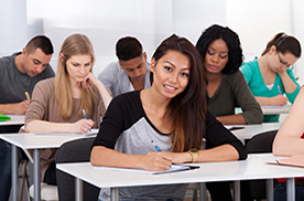 happy female student in a classroom with other students