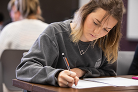 a girl writing in class
