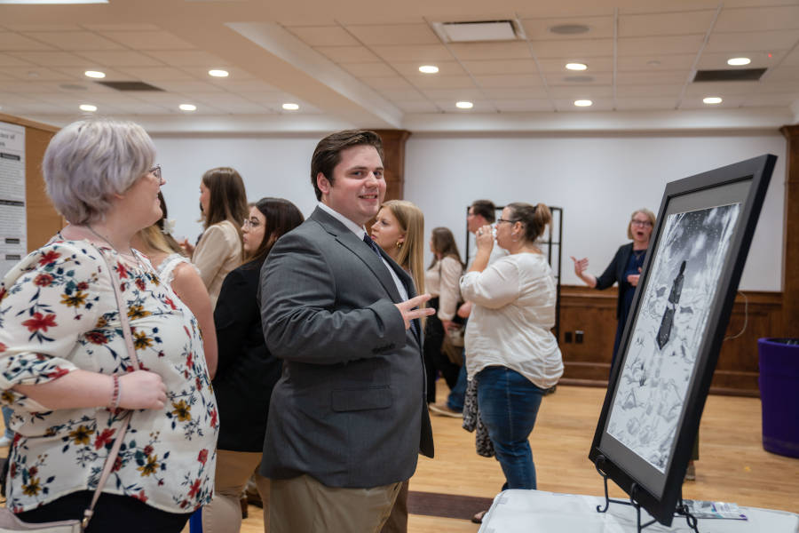 A student presents during the poster segment of the Undergraduate Research Conference